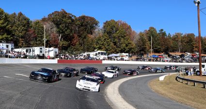 Pro Late Models enter turn 4 at Caraway Speedway under the preliminary pace laps.